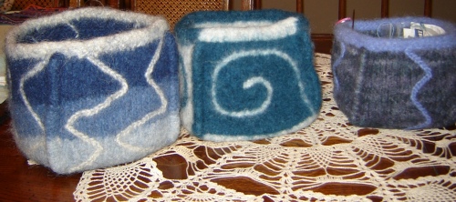 three wool-felt boxes